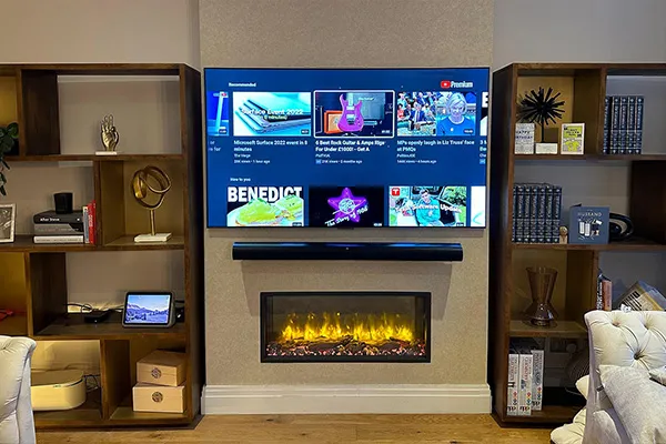 TV wall mounted above fireplace — sleek London installation.