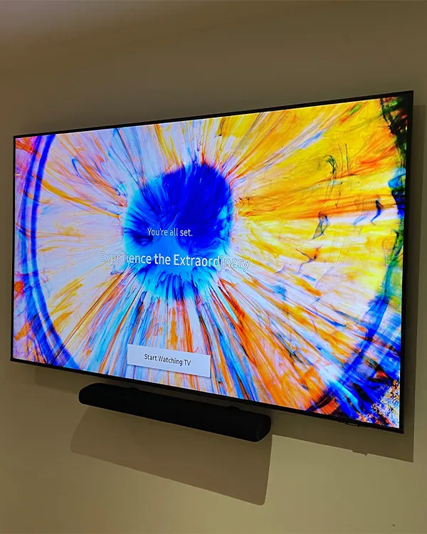 London TV installation on plaster wall with soundbar and hidden cables.