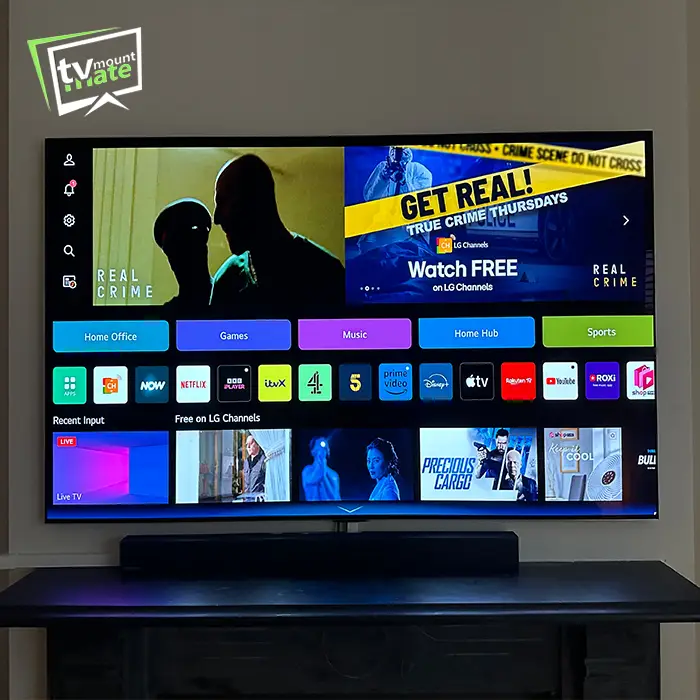 TV mounted on chimney breast with soundbar and side cable route