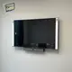 Soundbar installed below a wall mounted TV with tidy cable setup