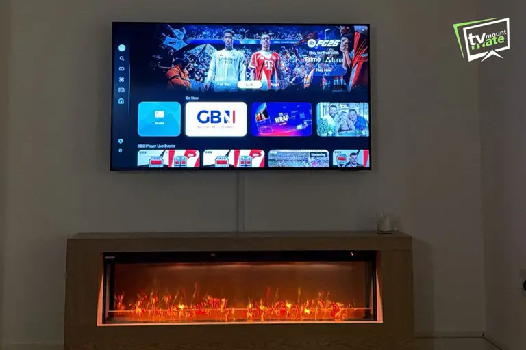 TV Mounting Above Fireplaces 5 55-inch LG TV mounted above an electric media wall fireplace with concealed cables and a full-motion bracket in Cockfosters.