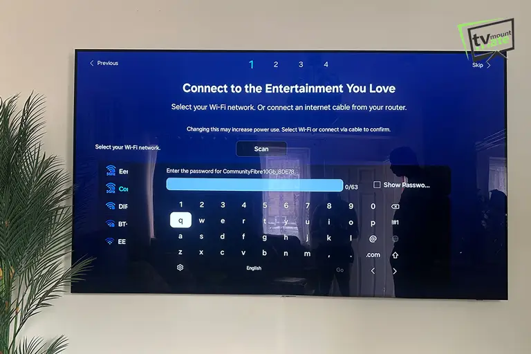 65-inch Samsung TV mounted on a brick wall