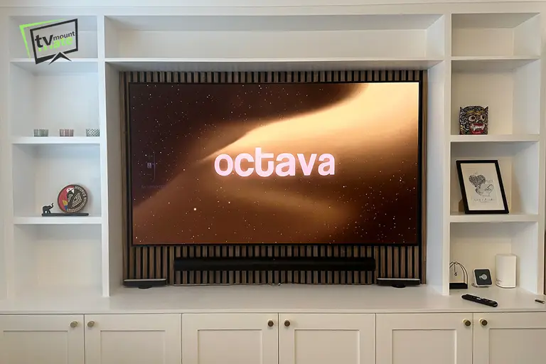Samsung soundbar installed below Samsung S95F TV in Lon