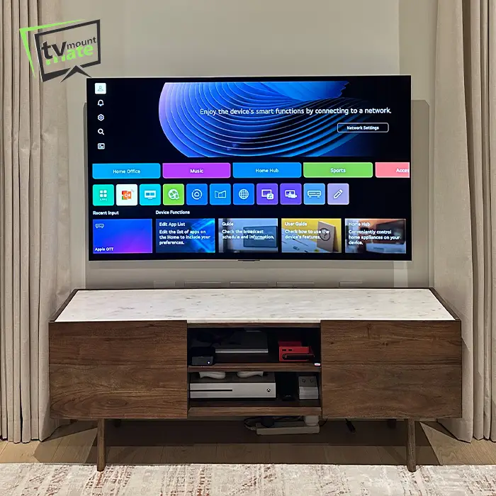 Clean TV cable concealment with hidden HDMI cables behind wall-mounted TV