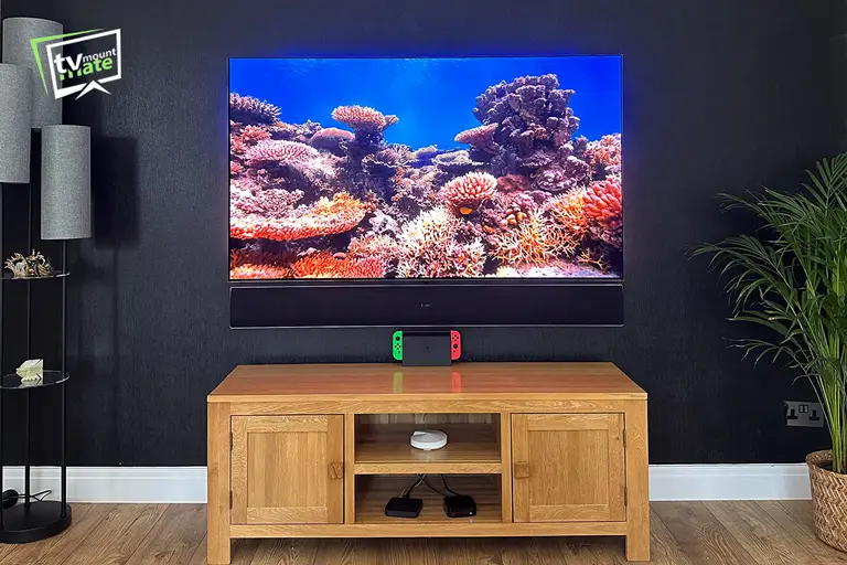 65-inch LG G5 OLED and LG soundbar mounted on a black brick feature wall in Northwood, Hillingdon.