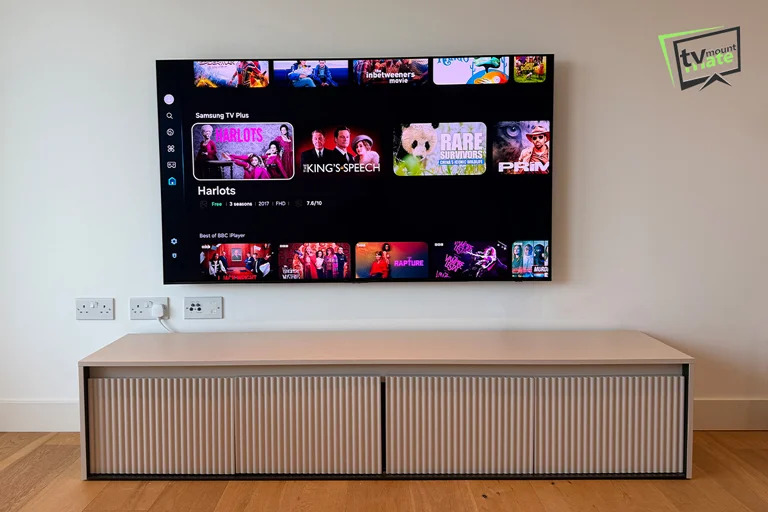 65-inch Samsung S90F television mounted on a plasterboard wall in Greenwich